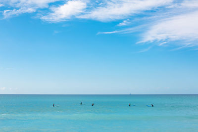 People surfboarding in sea