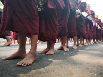 Low section of people standing on street