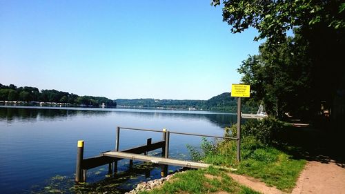 Scenic view of calm lake against clear sky