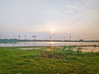 Scenic view of lake against sky during sunset