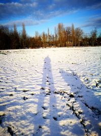 Snow covered landscape against sky