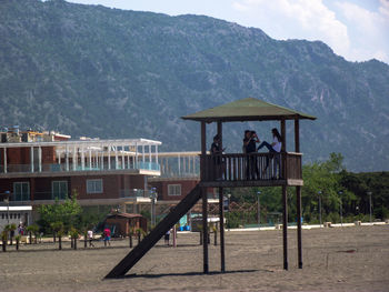 People at observation point against mountain