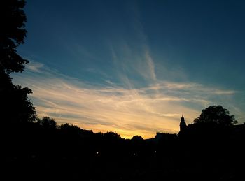 Silhouette of trees against sky at sunset