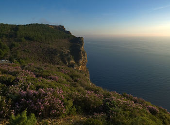 Scenic view of sea and mountains against sky