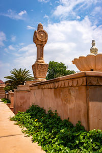 Artistic red stone jain god holy pillar with bright blue sky at morning from unique angl