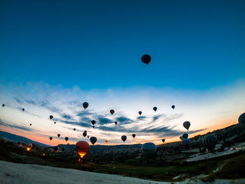 Low angle view of hot air balloons flying in sky