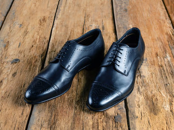 High angle view of shoes on wooden floor