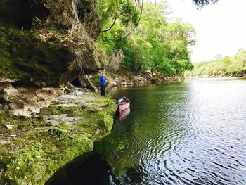 Man on rock by river