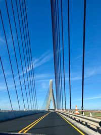 Low angle view of suspension bridge against sky