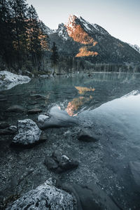 Scenic view of lake by mountains against sky