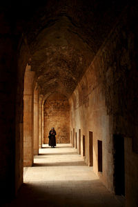 Rear view of man in corridor of building