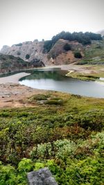 Scenic view of lake and mountains against sky