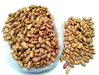 High angle view of coffee beans against white background