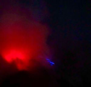 Low angle view of illuminated lights against sky at night