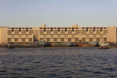 Building by sea against clear sky