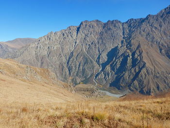 Scenic view of mountains against clear blue sky