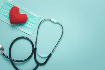 Close-up of heart shape on table against blue background