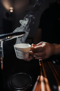 Midsection of man preparing drink