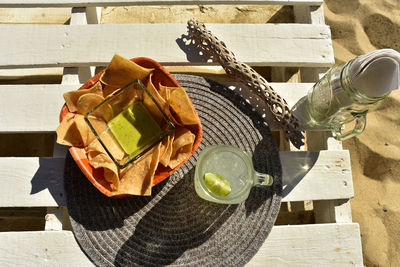 Snack of green salsa, tortilla chips and lemonade on table at beach in baja california sur, mexico