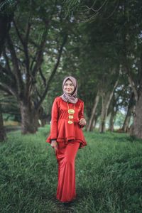 Smiling young woman walking in park