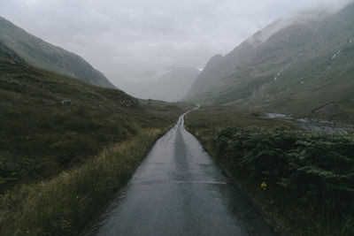 Scenic view of mountains against cloudy sky