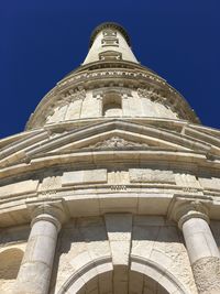 Low angle view of historical building against blue sky