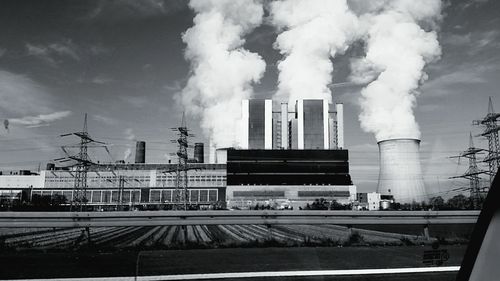 Industrial factory against cloudy sky