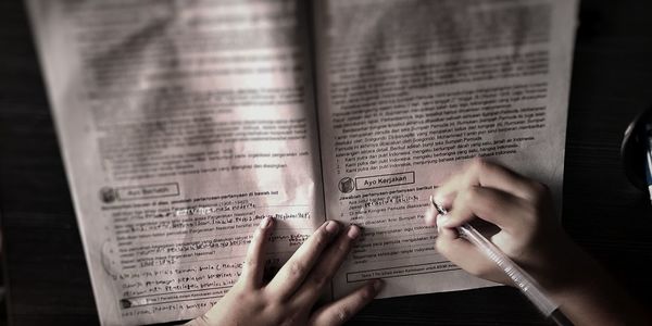 Midsection of woman reading book