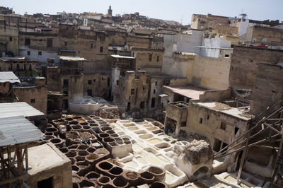 High angle view of tannery amidst houses in city on sunny day