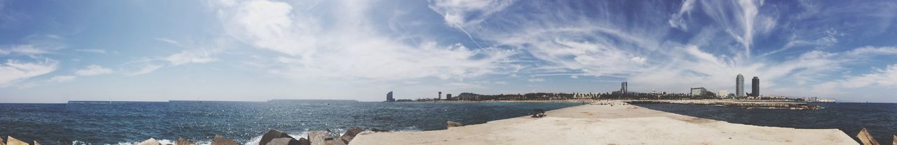 water, sky, sea, built structure, architecture, cloud - sky, building exterior, panoramic, cloud, blue, city, sunlight, nature, day, cloudy, scenics, beauty in nature, waterfront, outdoors, river