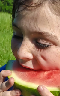 Close-up of girl eating watermelon