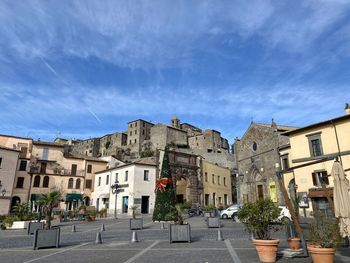 Buildings in town against sky