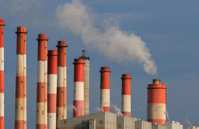 Smoke stacks against sky