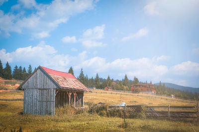 House on field against sky