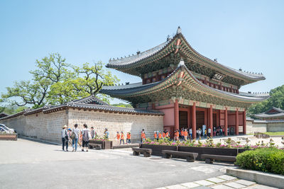 Tourists at pagoda during sunny day