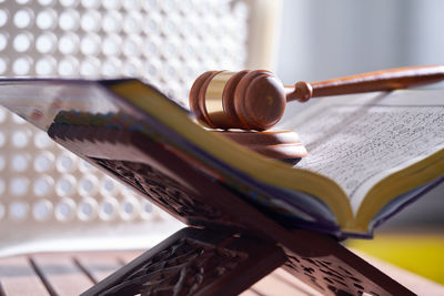 Close-up of gavel on book