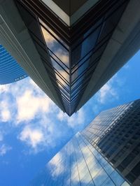 Low angle view of modern building against blue sky