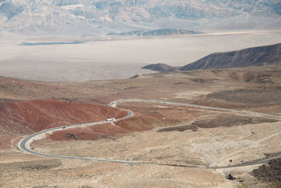 High angle view of road by mountains against sky