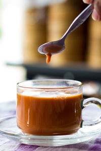 Close-up of coffee cup on glass