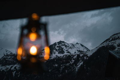 Illuminated snowcapped mountain against sky at night