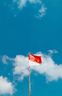 Low angle view of flag against sky