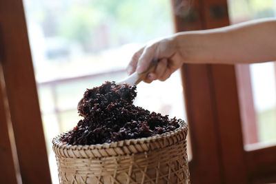 Midsection of person holding ice cream in basket