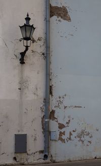 Low angle view of street light against wall