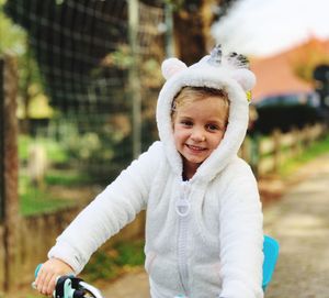 Portrait of cute smiling girl riding bicycle