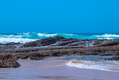 Scenic view of sea against clear blue sky