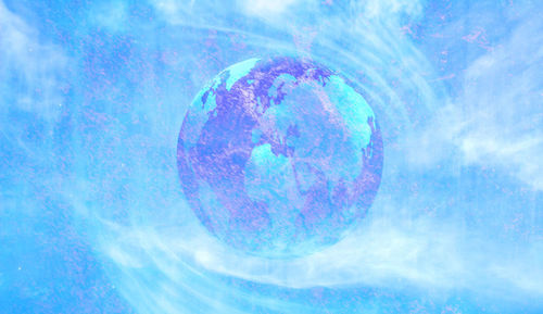 Close-up of bubbles in water against blue sky