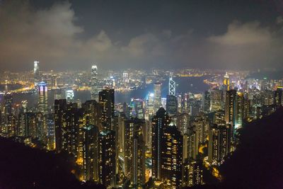 Illuminated cityscape against sky at night