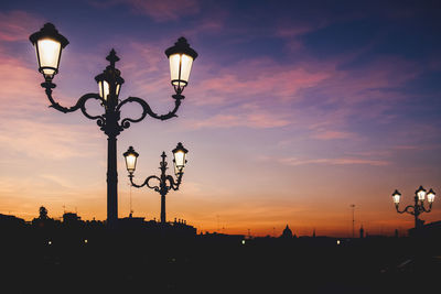 Silhouette street light against sky during sunset