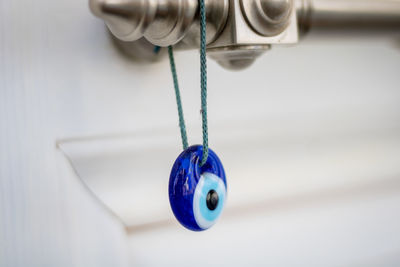 Evil eye bead hanging on door handle