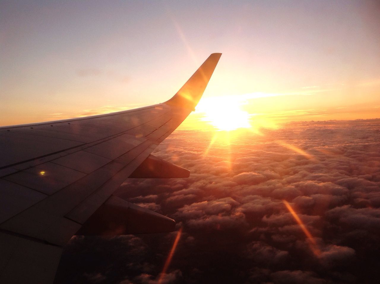 airplane, transportation, sunset, air vehicle, aircraft wing, flying, sun, mode of transport, sunlight, travel, sky, aerial view, airplane wing, jet engine, no people, beauty in nature, nature, outdoors, day